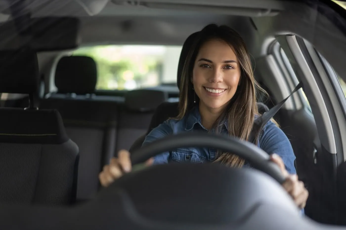 Smiling woman driving a car