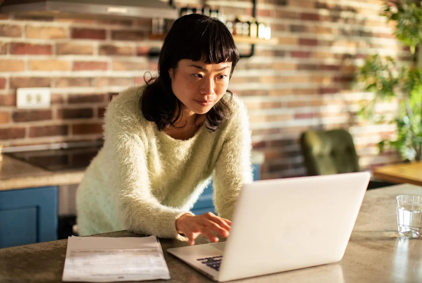 Close up of a young woman working from home on her laptop