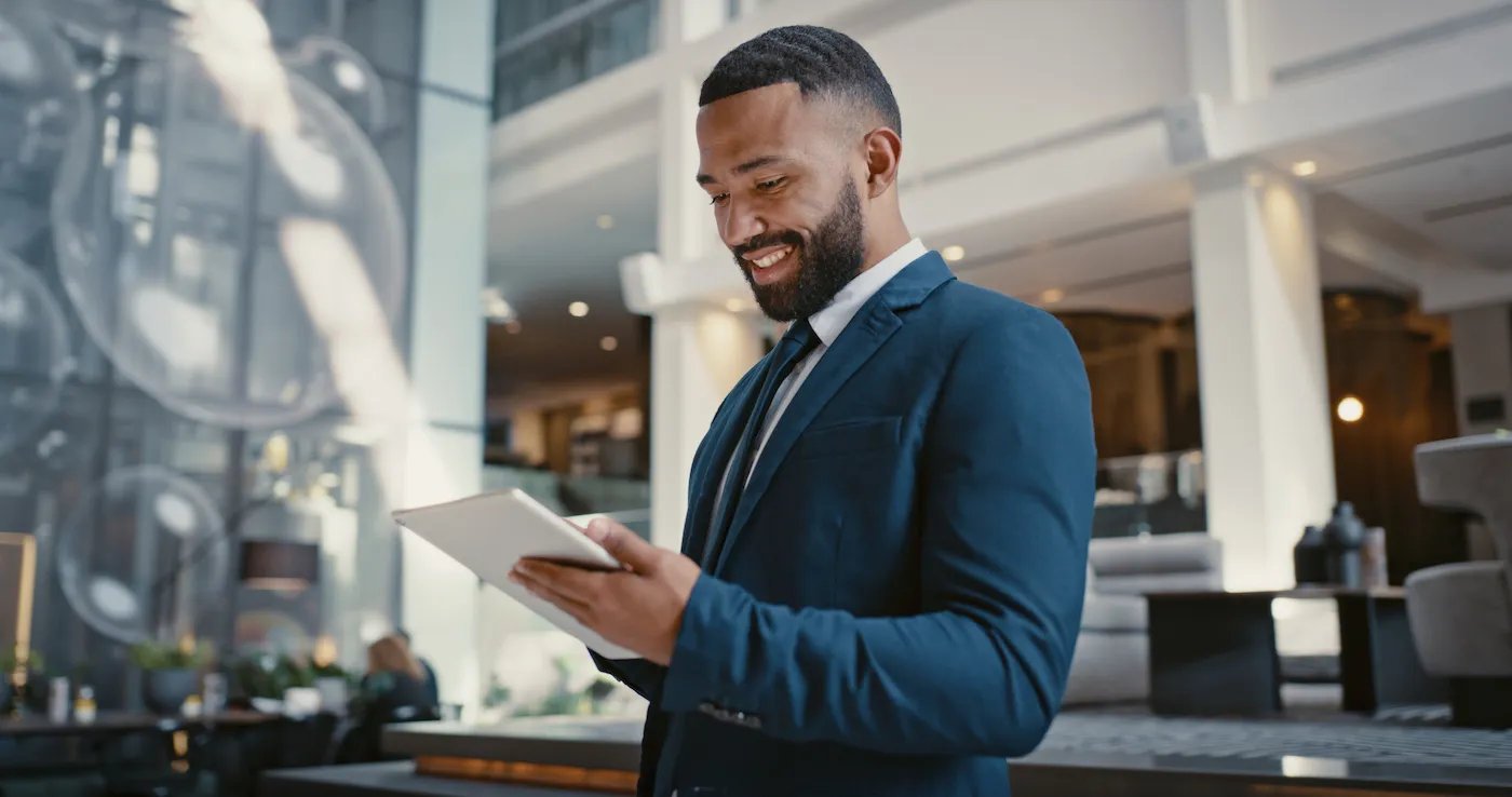 A man in a suit using a digital tablet to learn how money market funds work