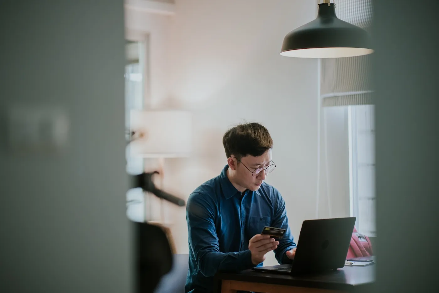 A man making a credit card payment using his laptop.