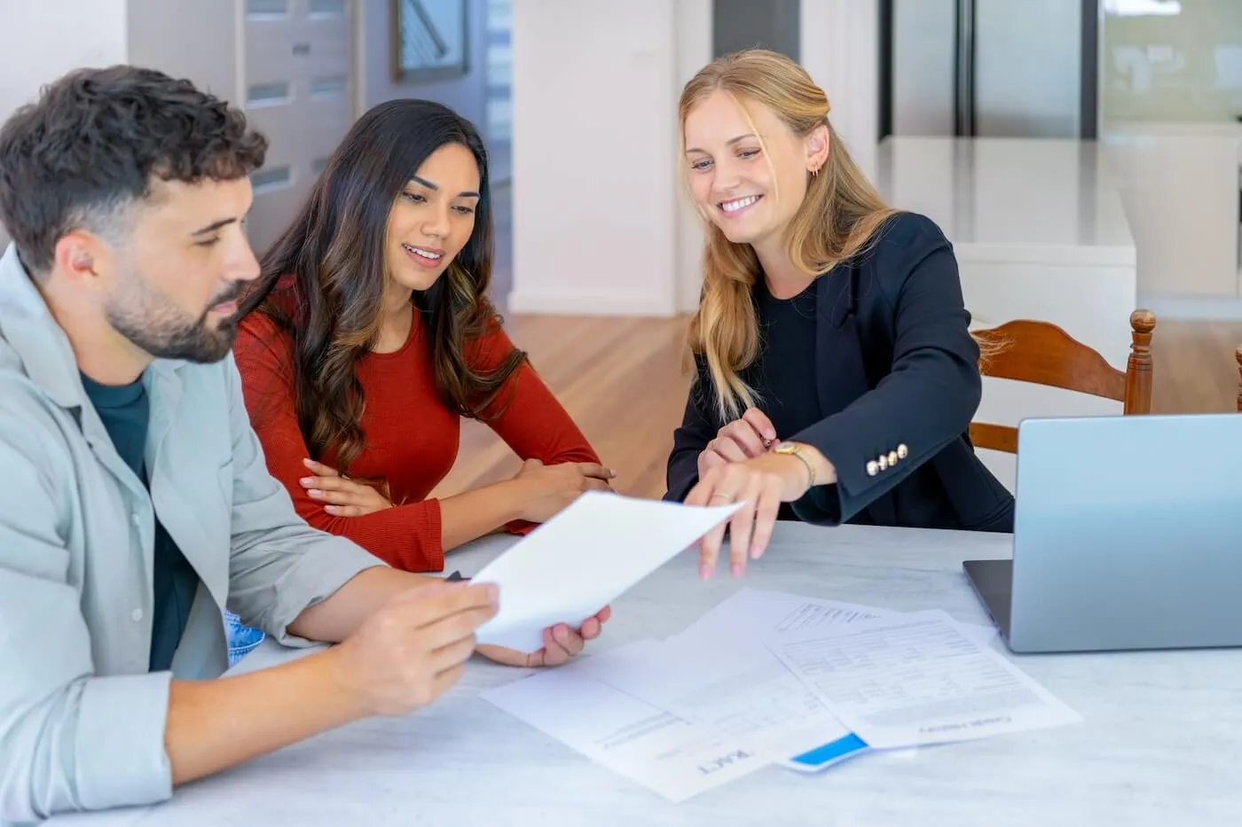 Broker is explaining the mortgage refinance terms to a young couple