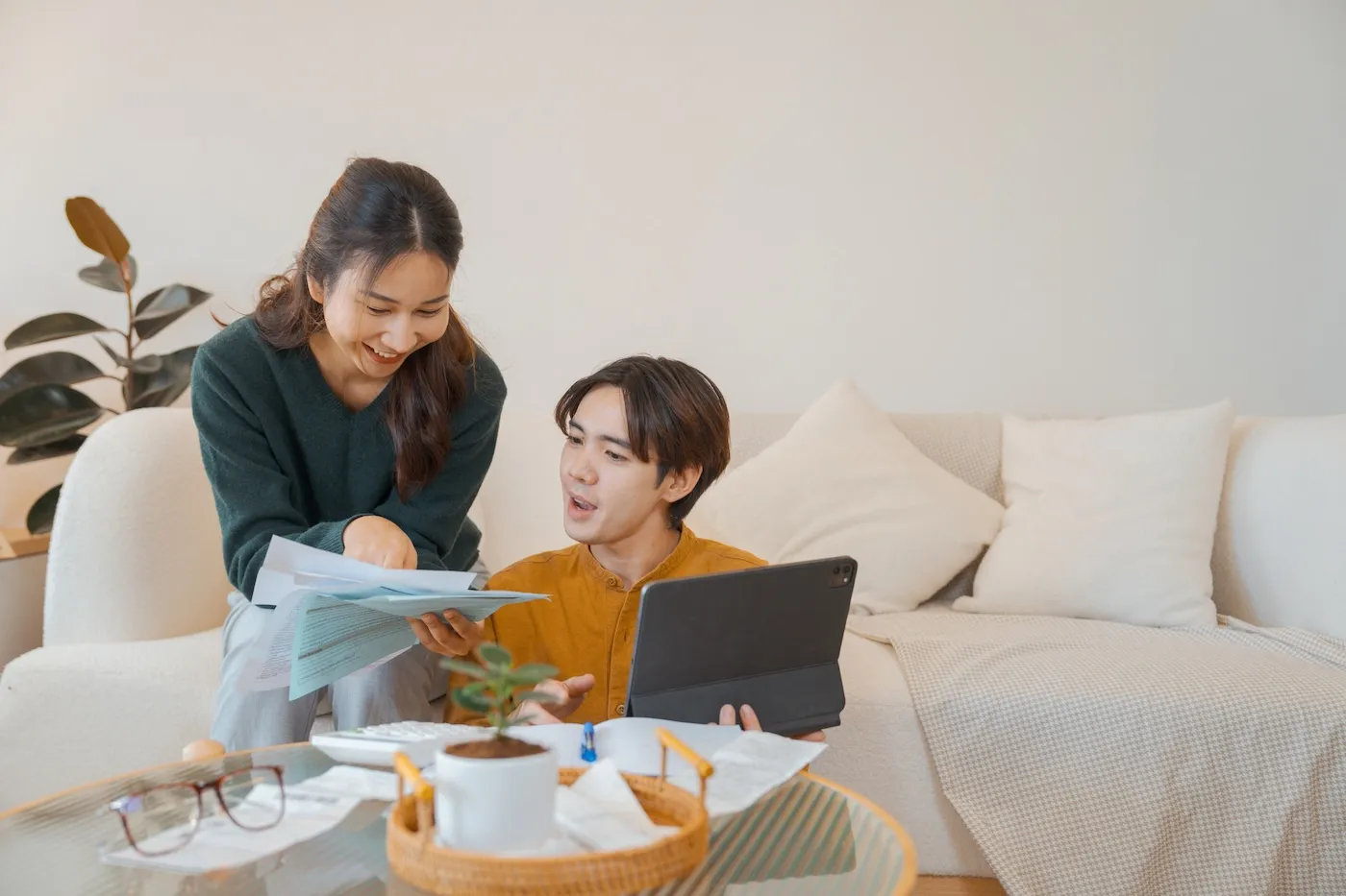 A couple managing bills and using a digital tablet at home.