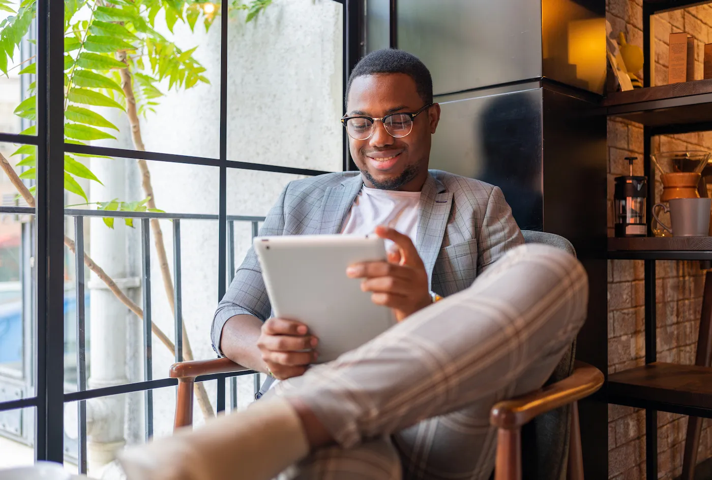 A Man Reading On Digital Tablet At Coffee Shop