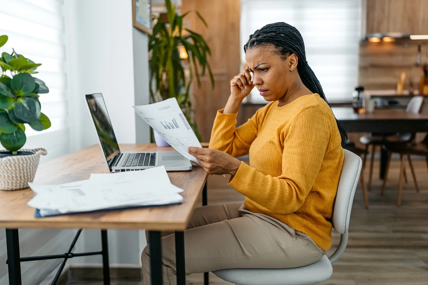 Concerned women reviewing her bills at her desk