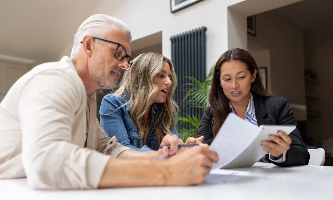 Financial advisor talking to a couple about their options to put their house in a trust.