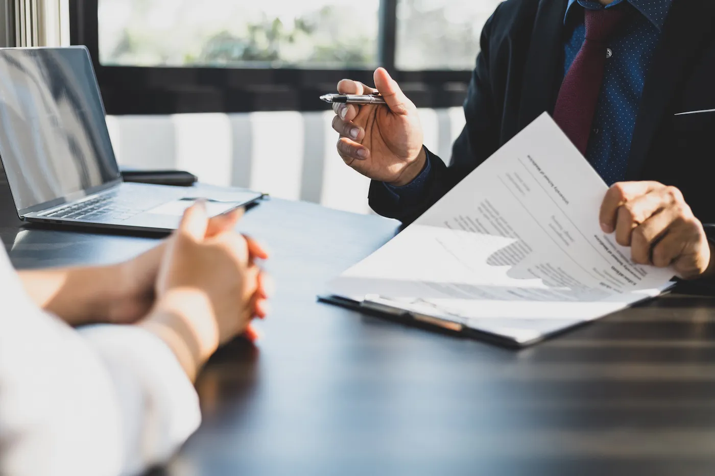 A person meeting with their financial advisor with paperwork in front of them.