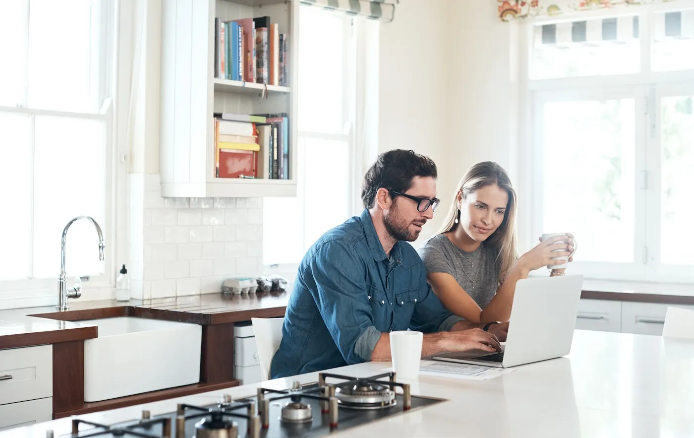 Shot of a young couple using a laptop together at home.