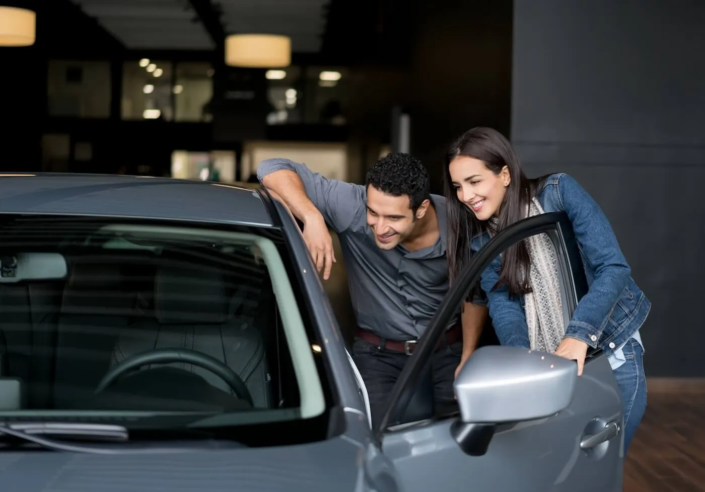 Couple checking a car before purchase