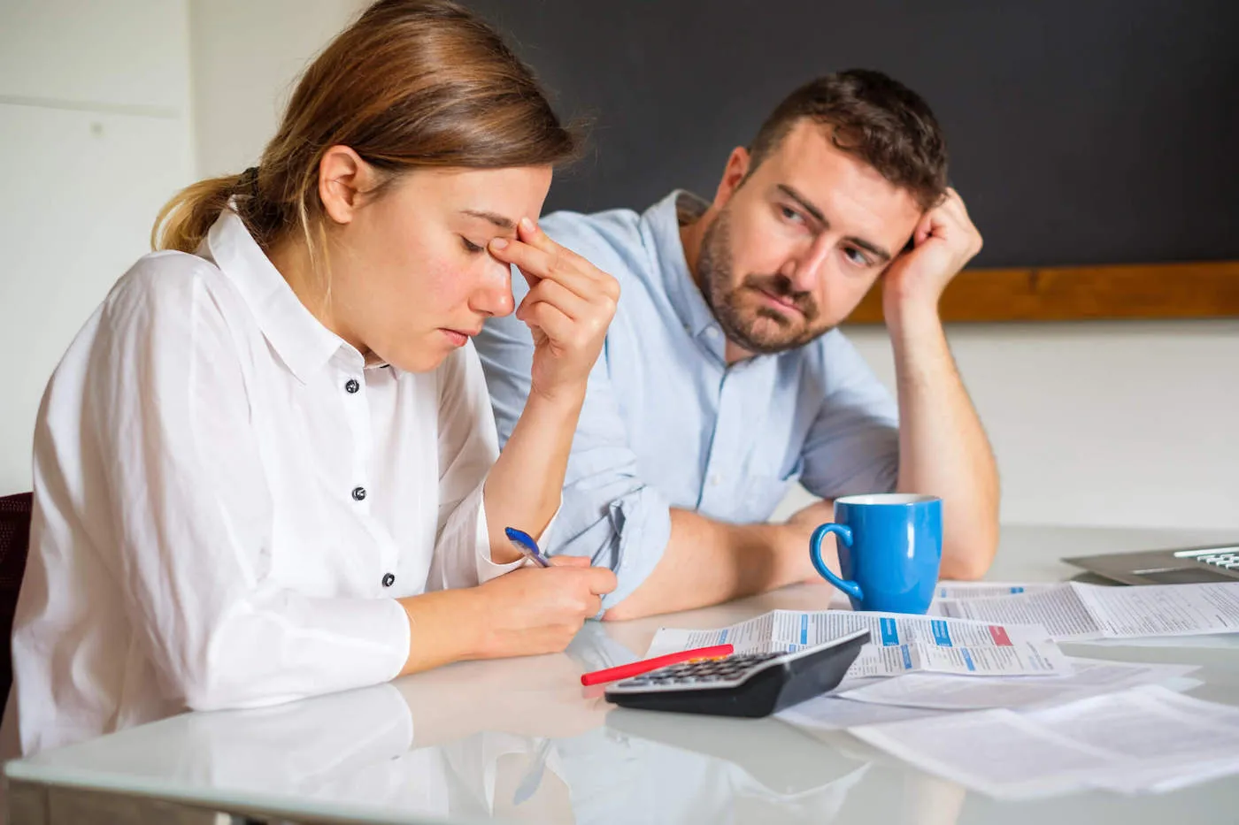 Man and woman couple struggling to pay essential bills.