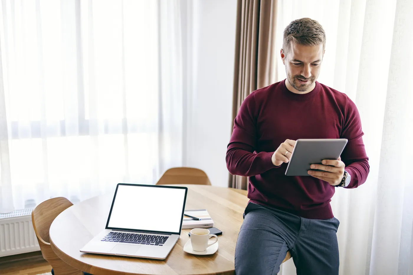 A man checking stocks on a digital tablet from home.