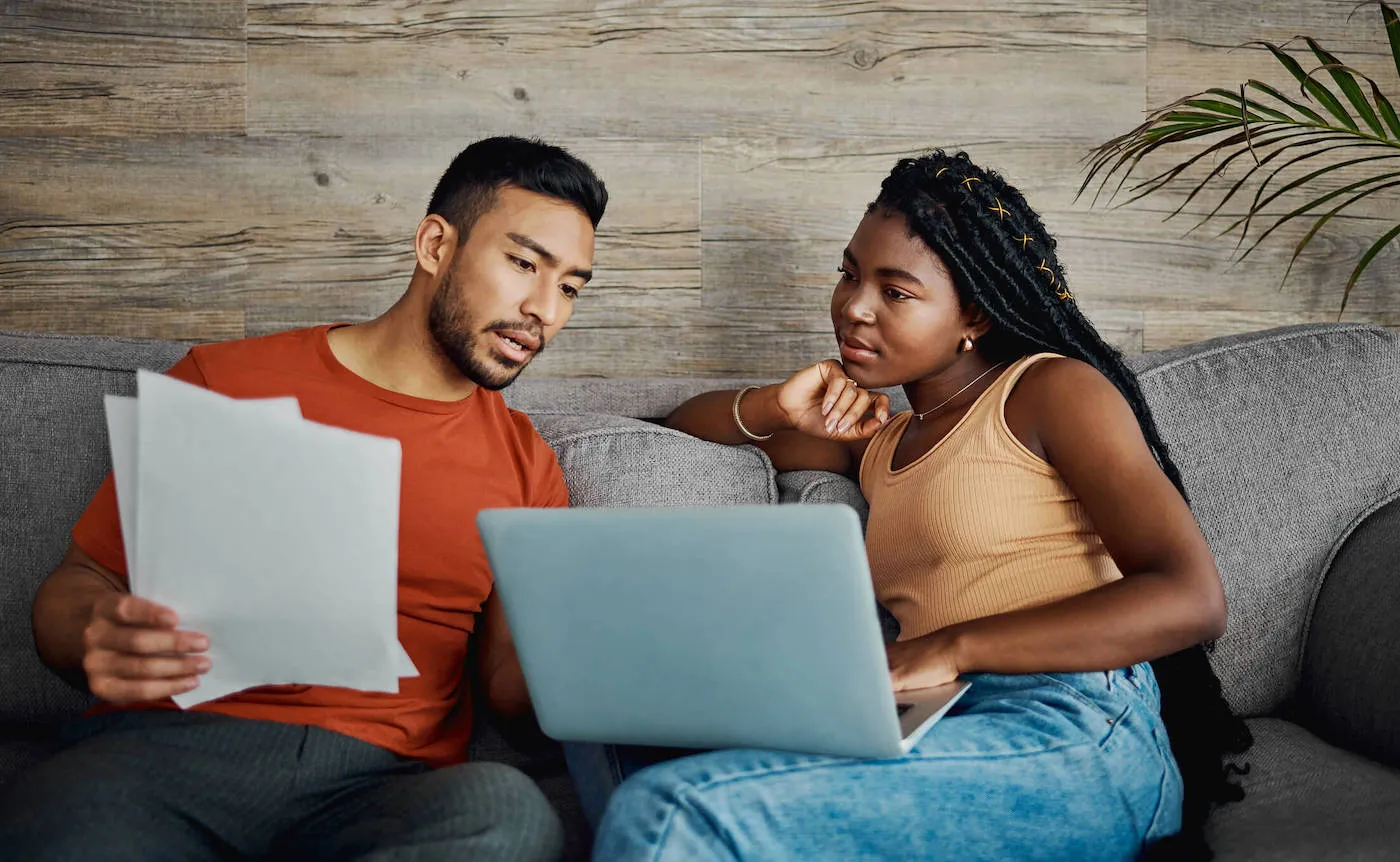 Man conversing with female over financial papers.