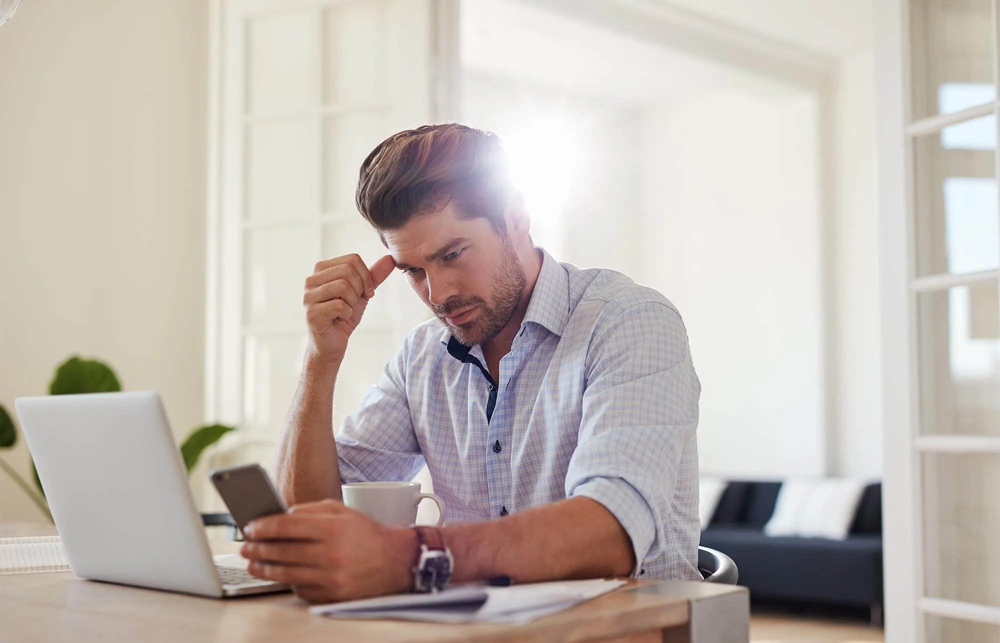 Man Focusing on Credit at Home