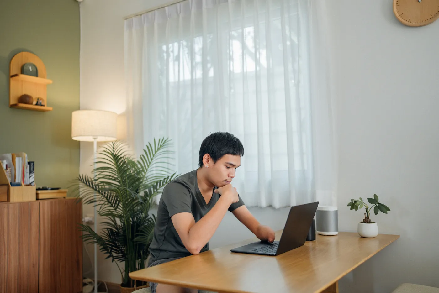 Man sitting at the table researching alternatives to short-term personal loans