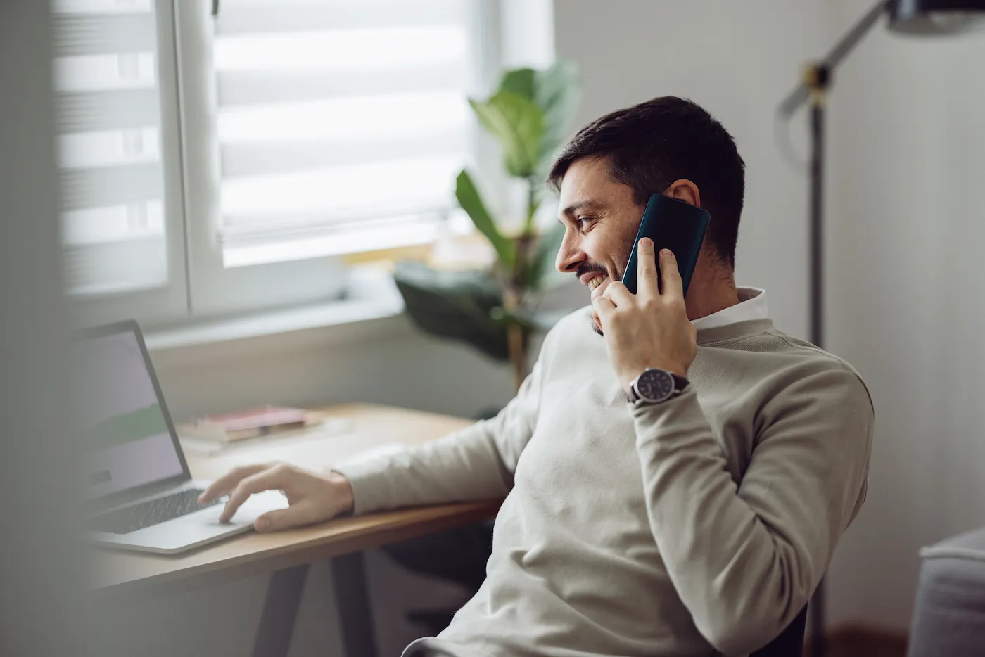 Man talking on his smartphone negotiating with debt collectors