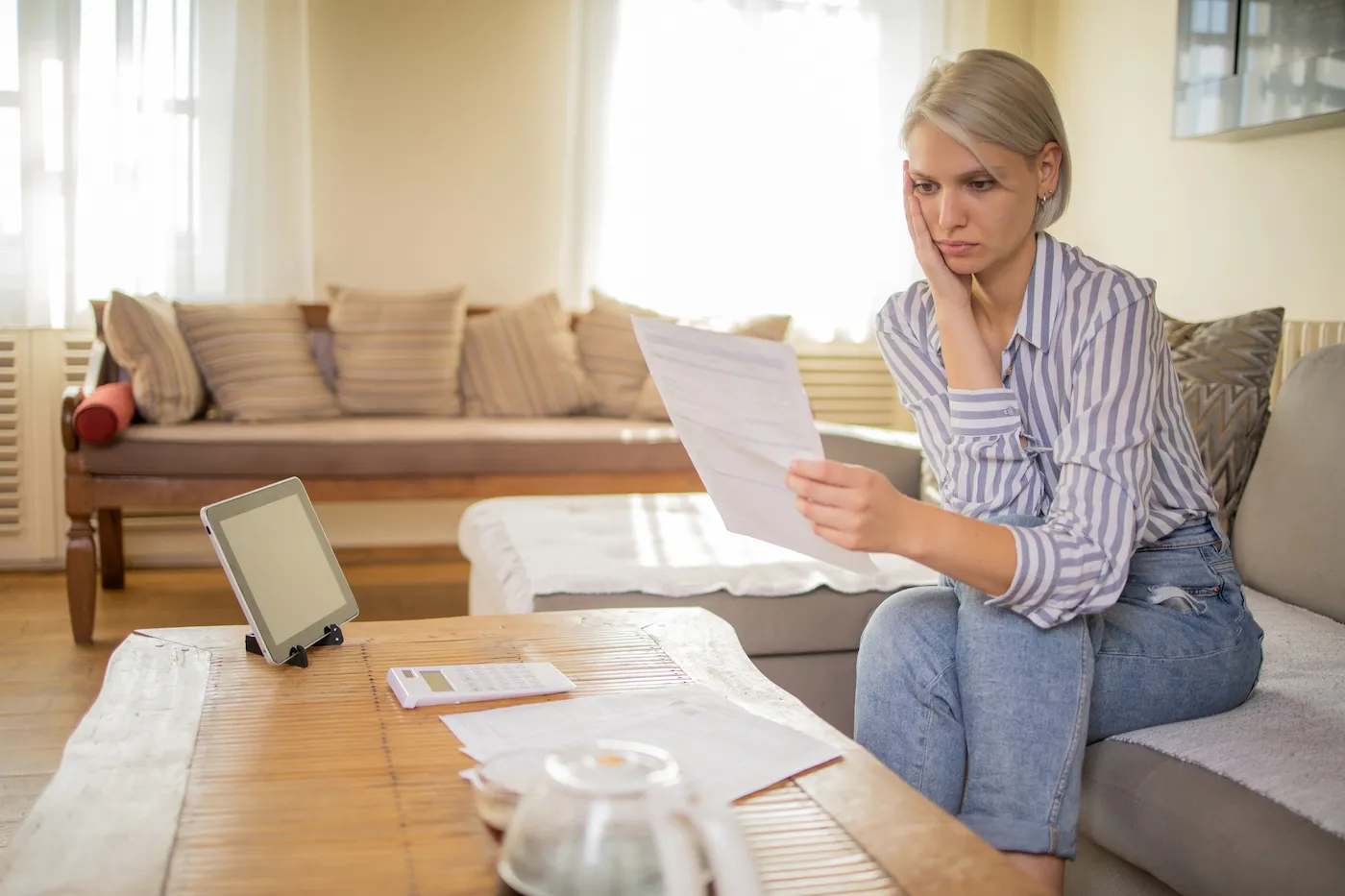 Woman looking at student loan bills