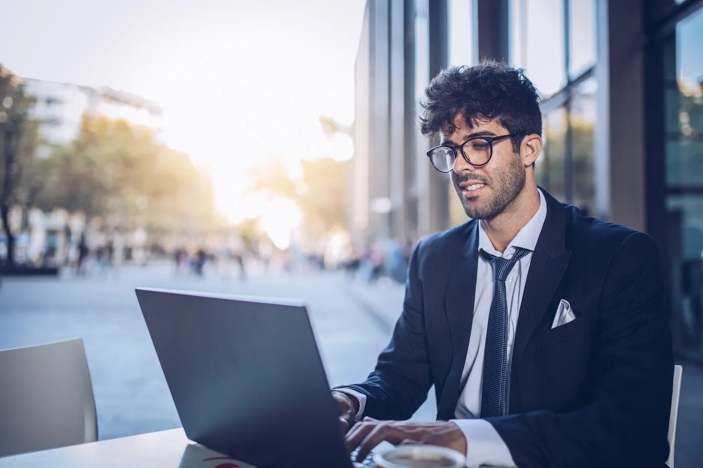 A businessman sitting in a cafe, using laptop.