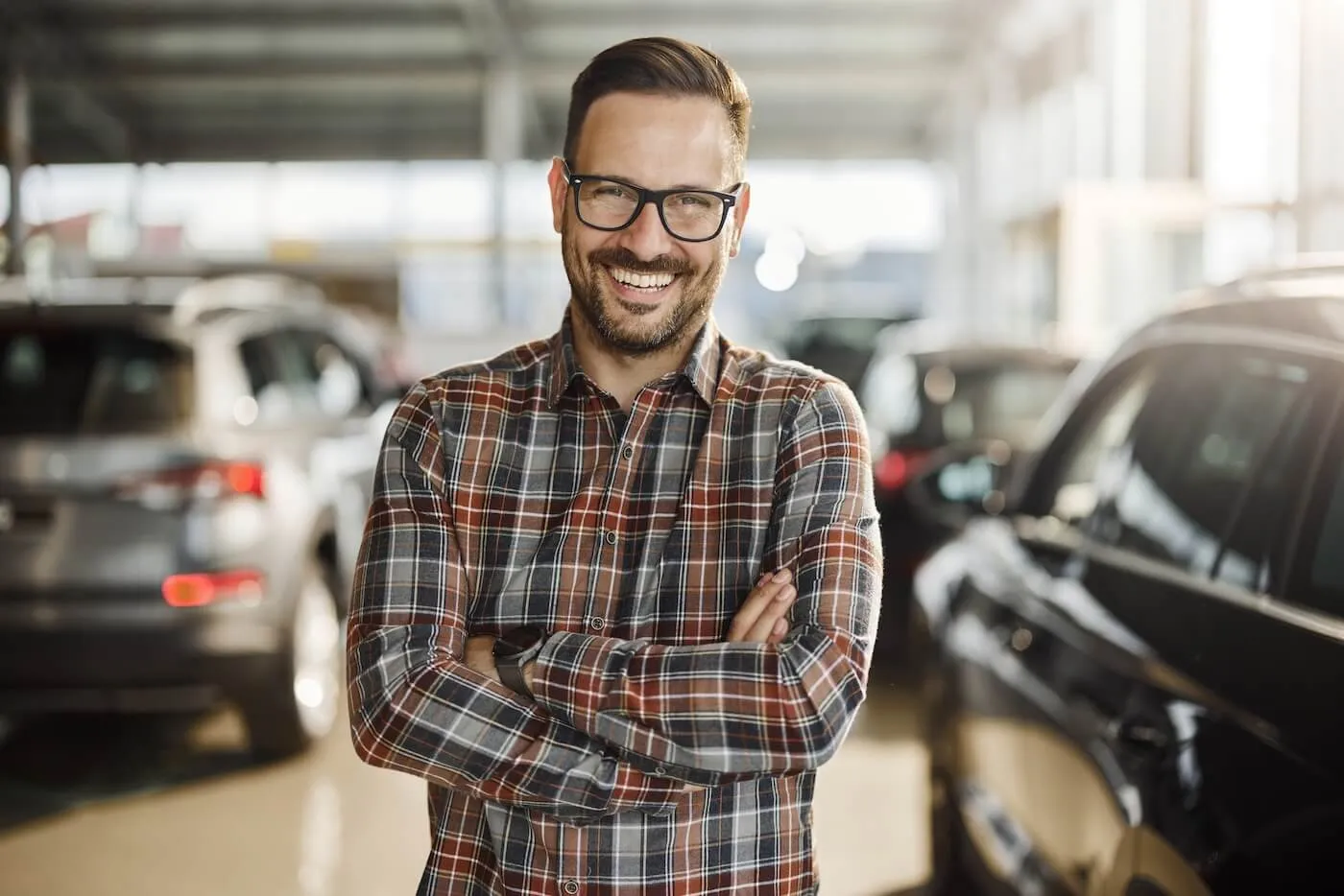 Smiling man in a car dealership