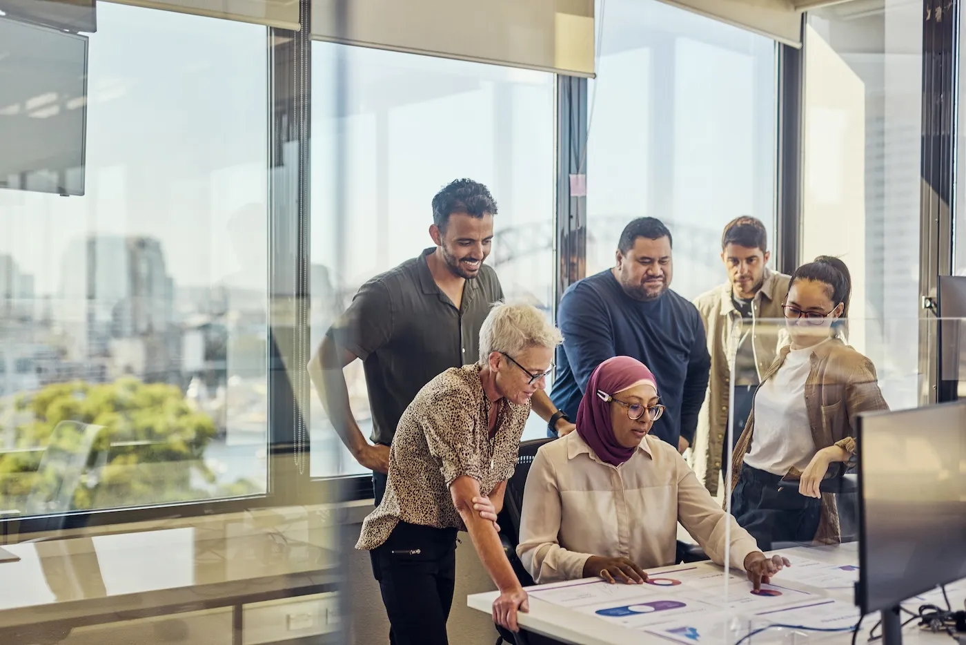 Teamwork and collaboration in a tech-driven Australian office with stunning Sydney views.