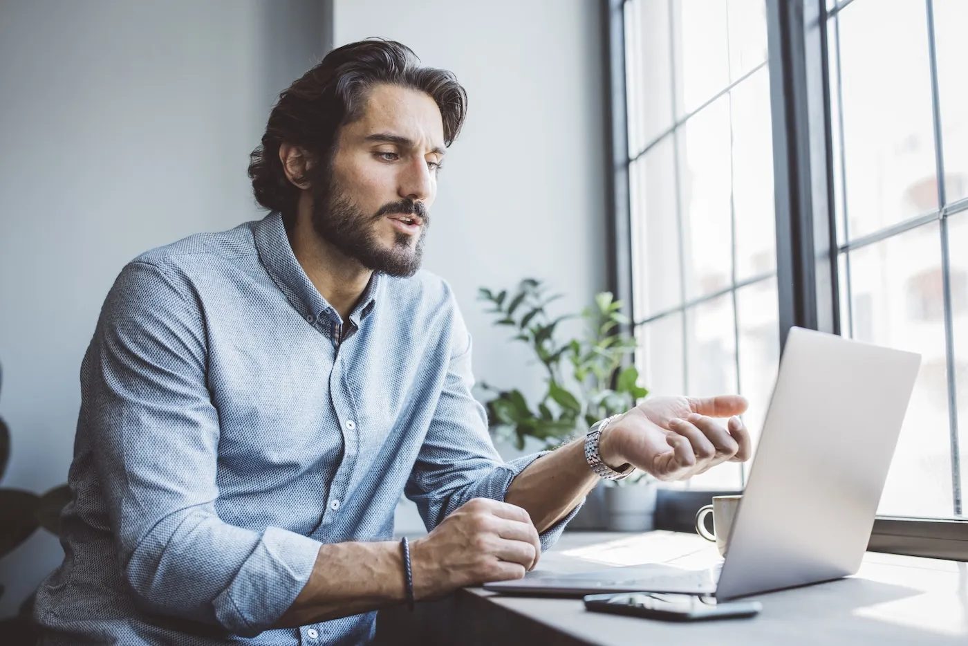 Businessman working from home using laptop.