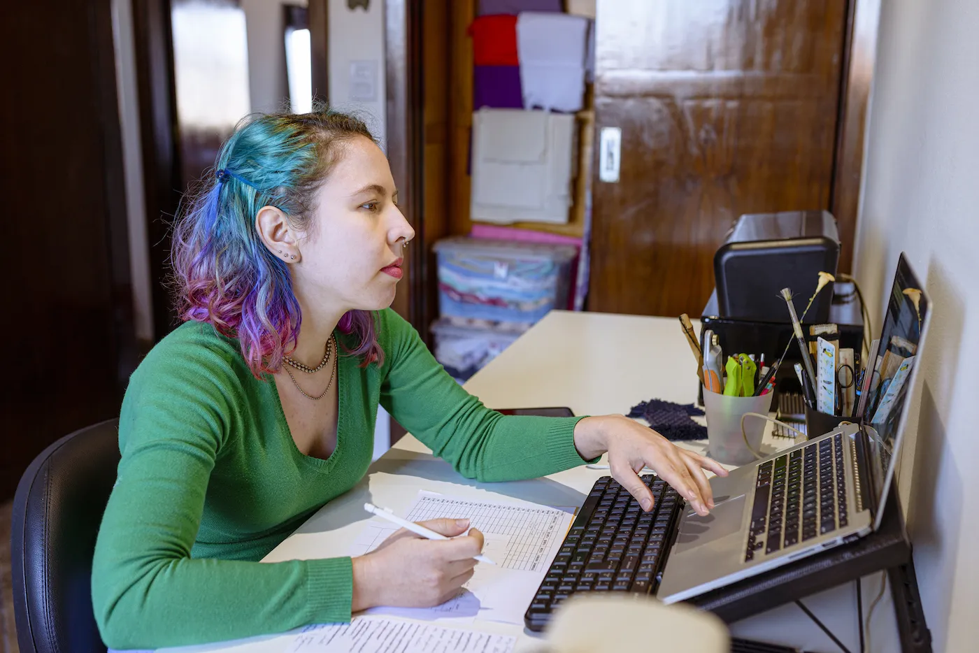 Young woman working in her home office.