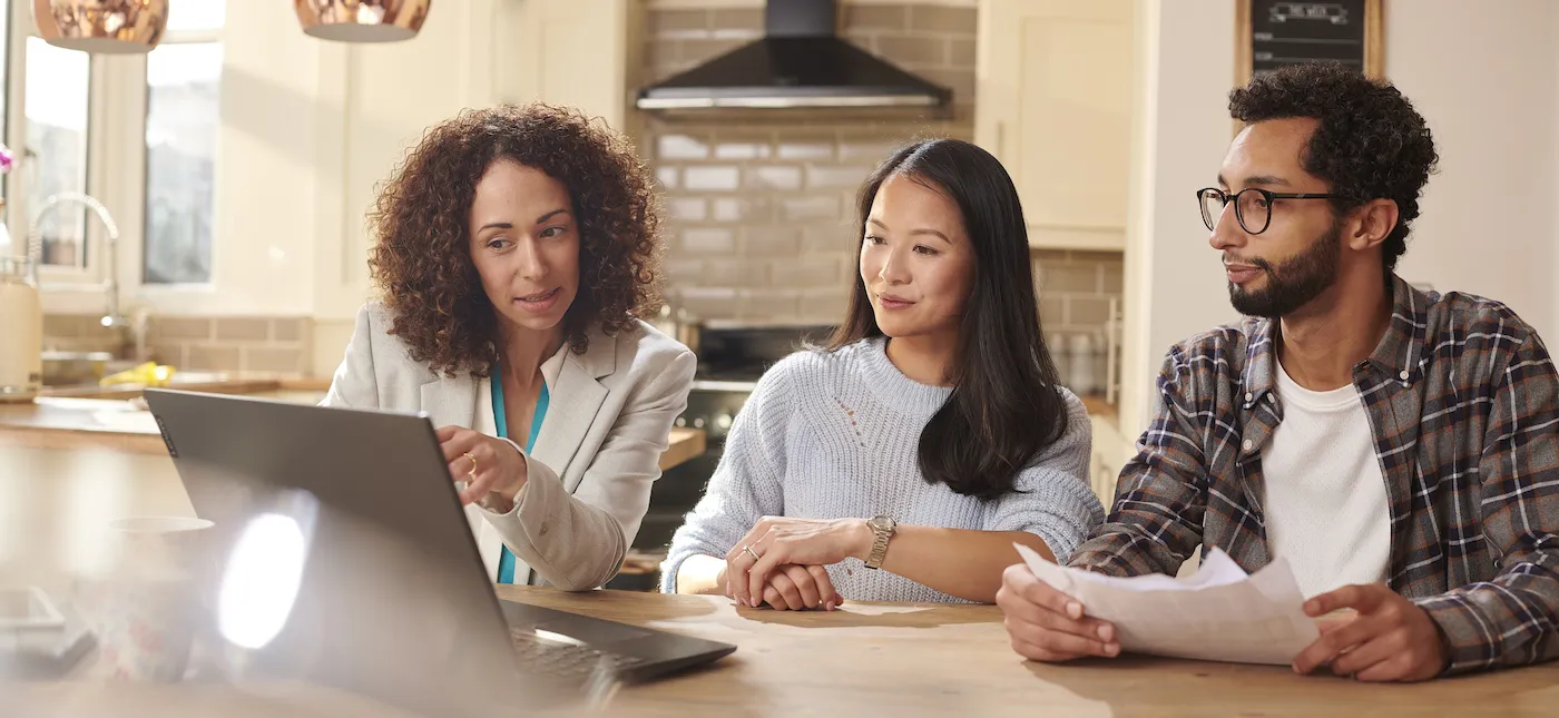 A couple meeting with their financial advisor to review their savings.