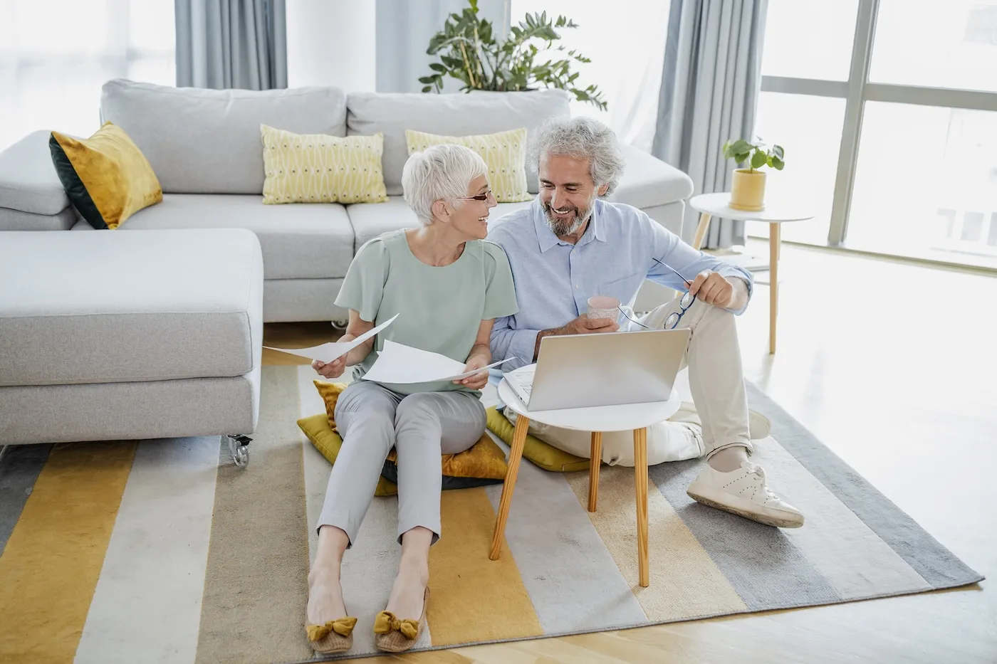 Senior man and woman are using laptop at home.