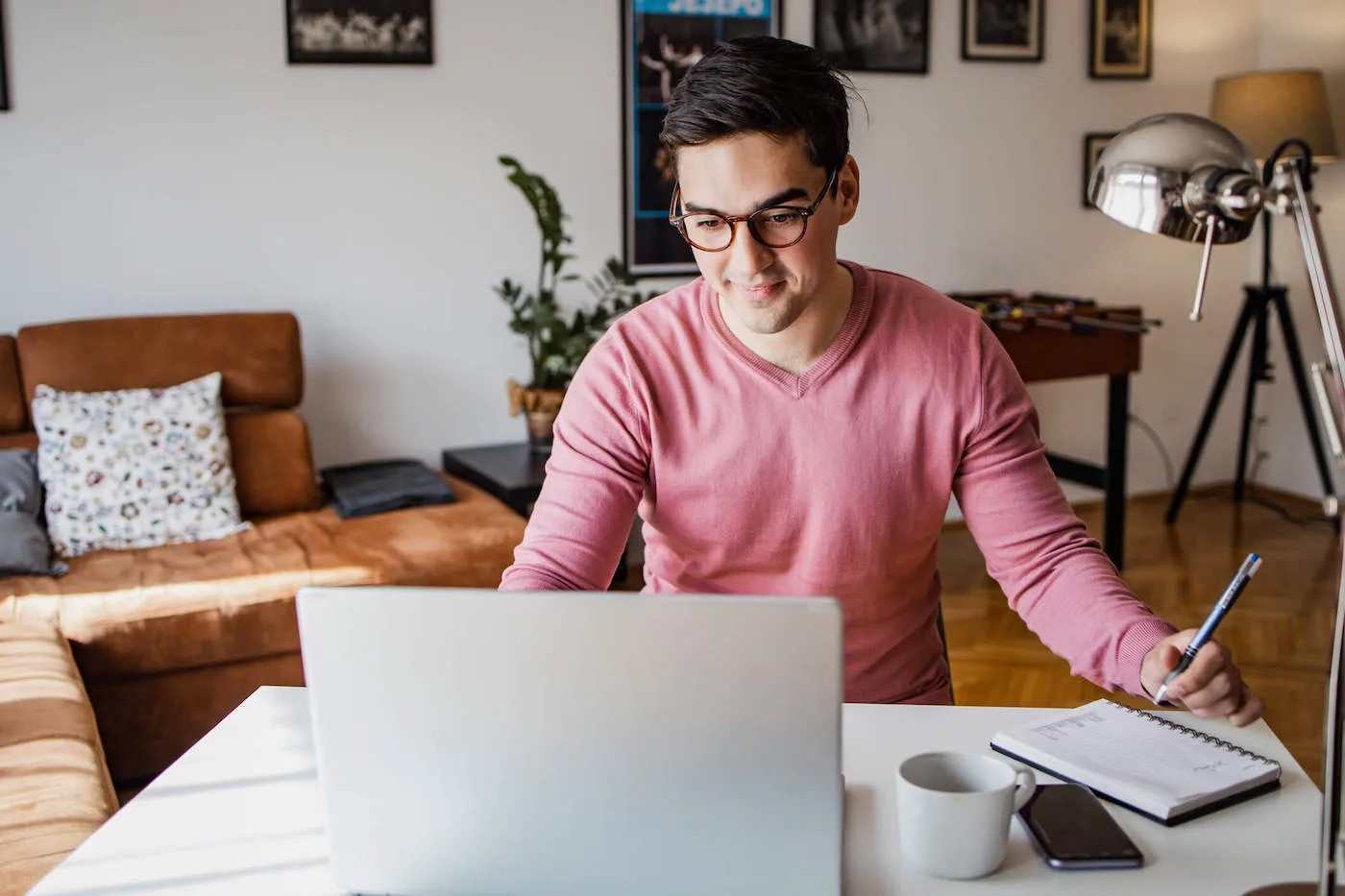 Seated man researching financial steps to take when roommate moves out.