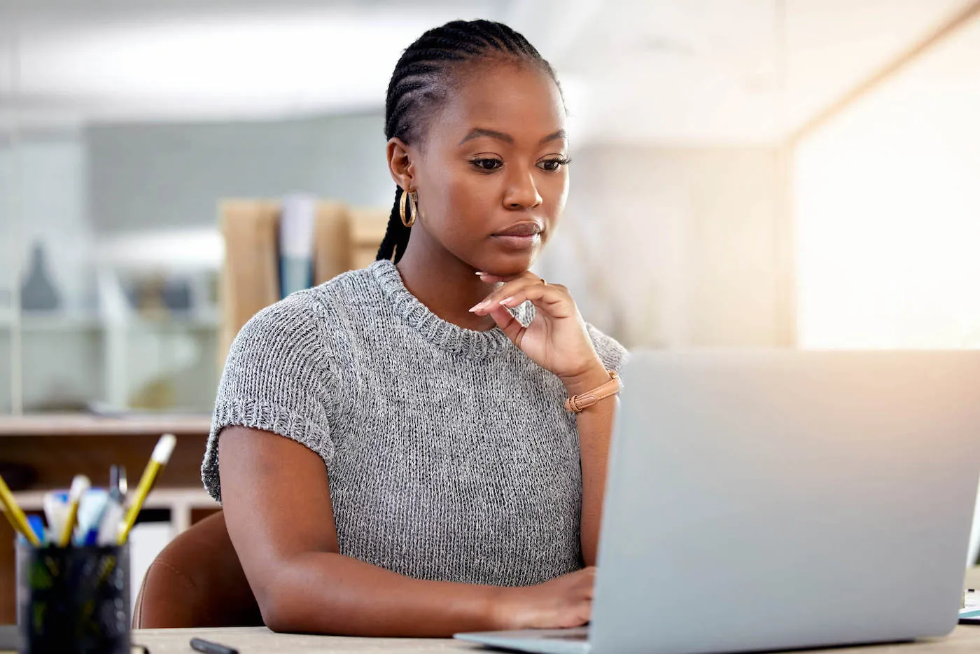 Seated woman concentrating on online search.