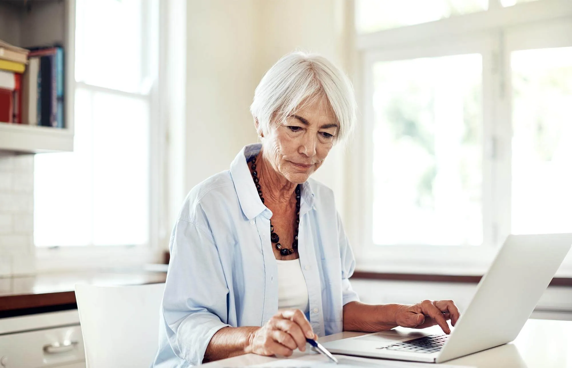 Senior Woman Working on Finance Kitchen