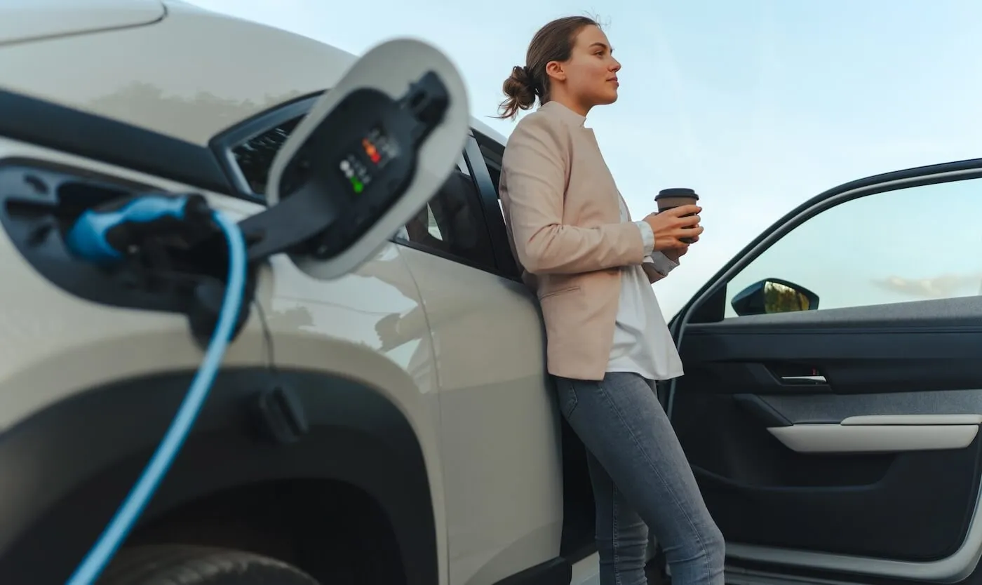 Woman charging her EV while having a coffee