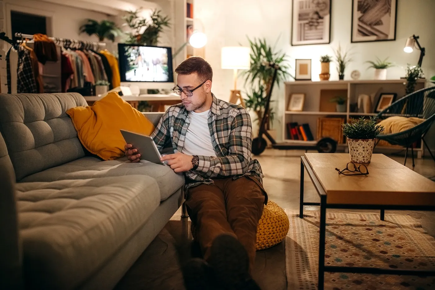 Man is sitting on the floor and using a laptop