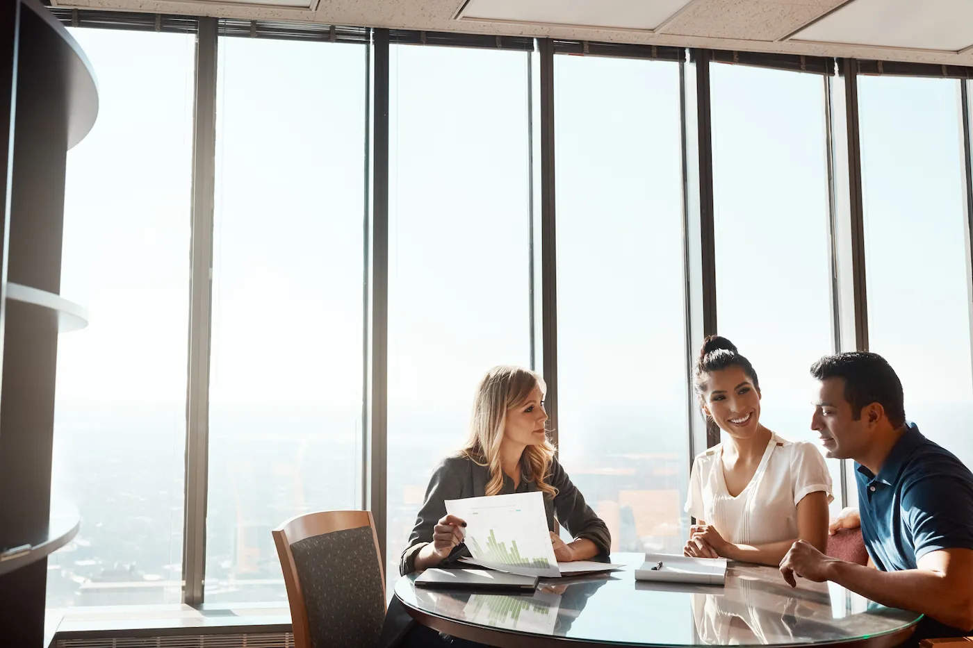 Shot of a young couple meeting with a financial planner in a modern office