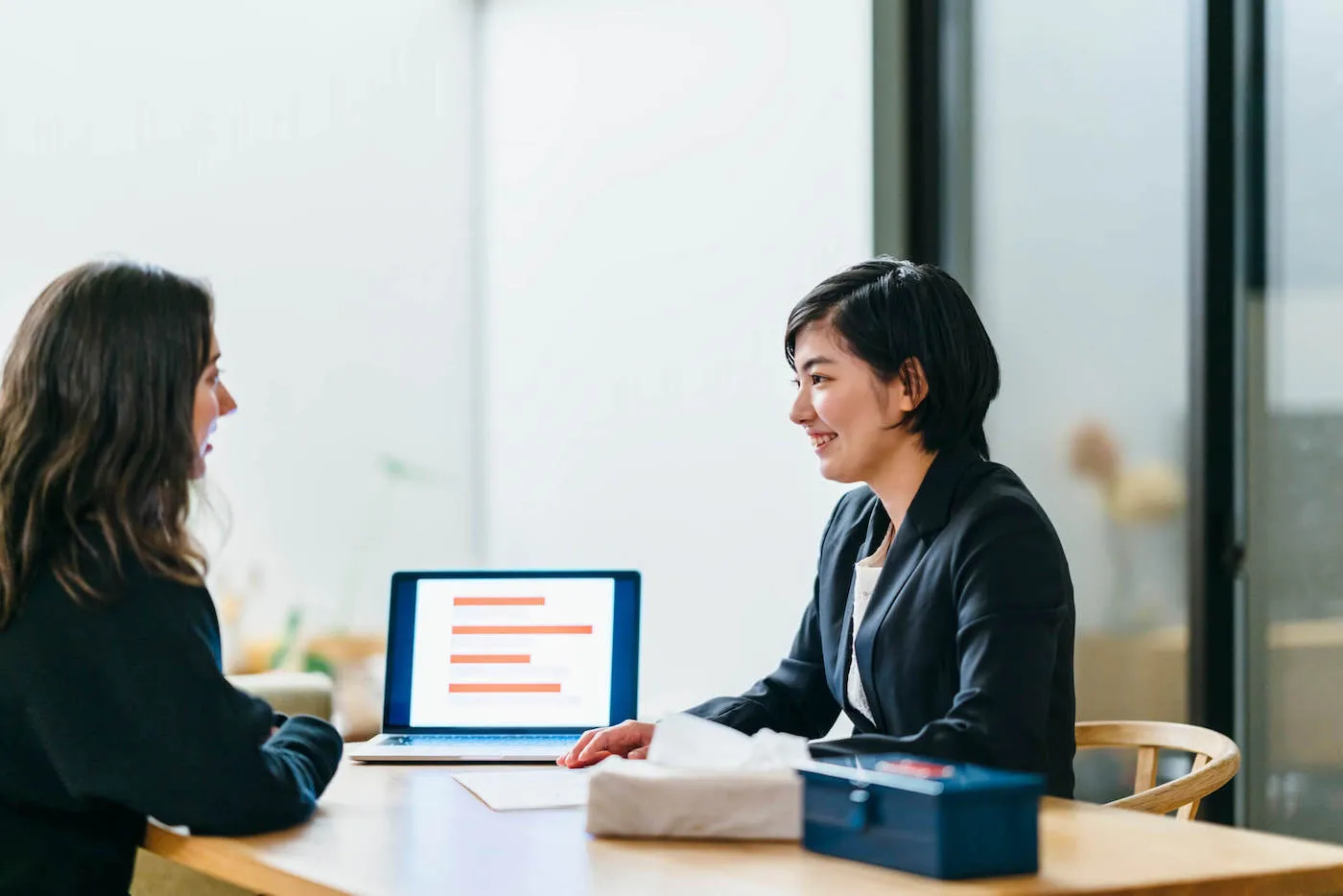 Two young women discussing which credit score is most important.