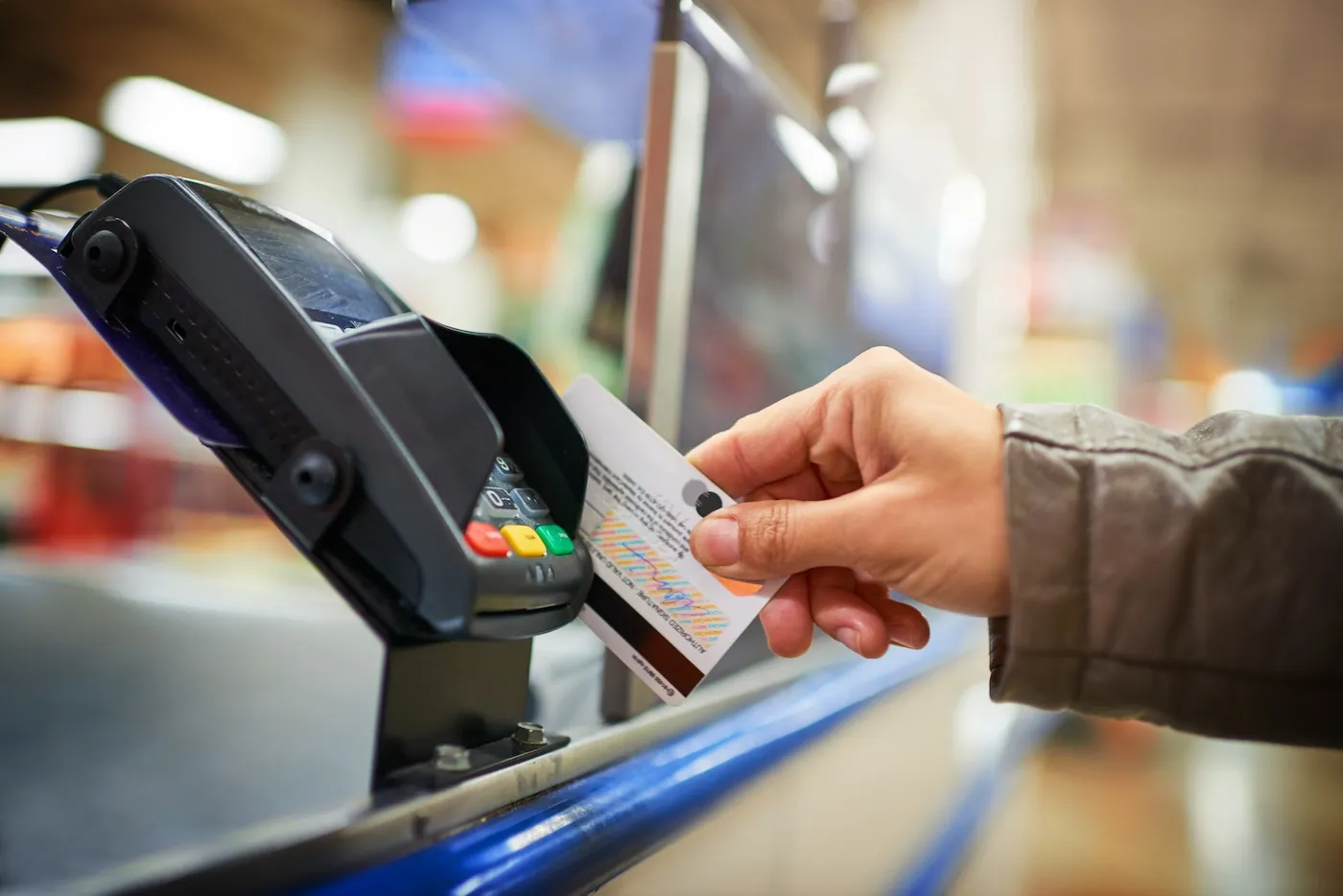 Cropped shot of an unrecognizable woman making payment in a store with a credit card