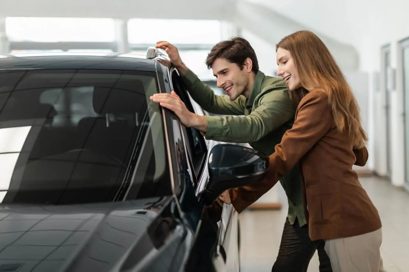 Young couple choosing a new car