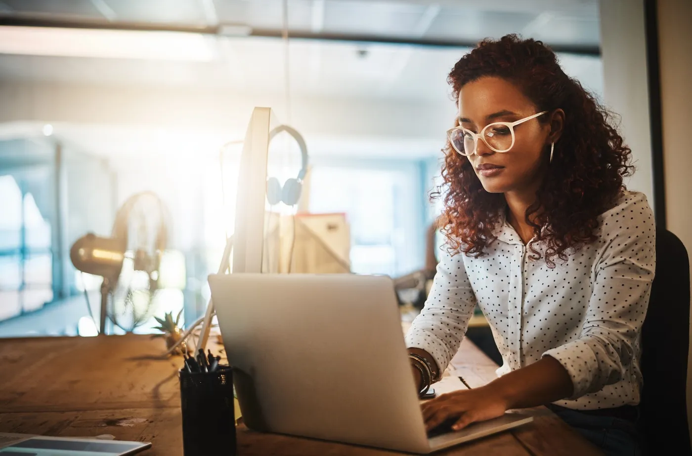 Shot of a young businesswoman using a laptop during a late night at work