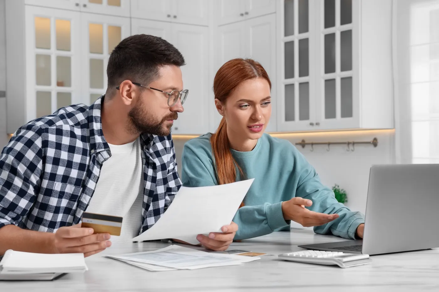 Couple with credit card looking at applications online.