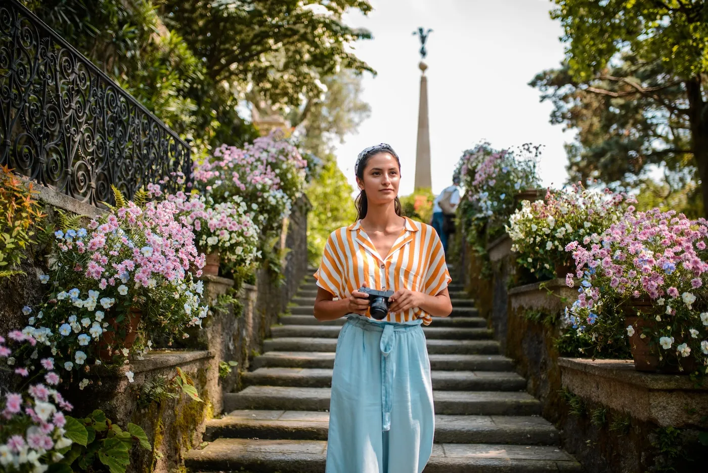 Female freelance photographer walking with camera in Europe.