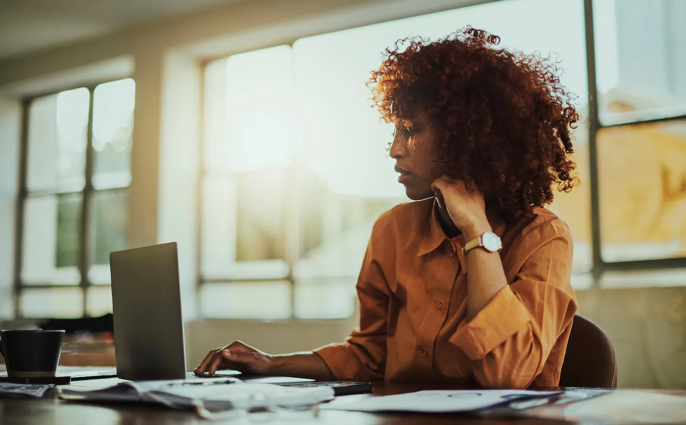 Woman researching NOW account on laptop