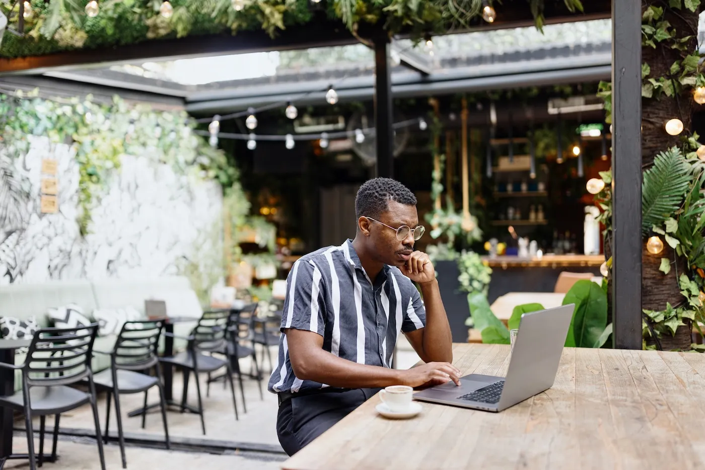 A man working on a computer at the cafe.