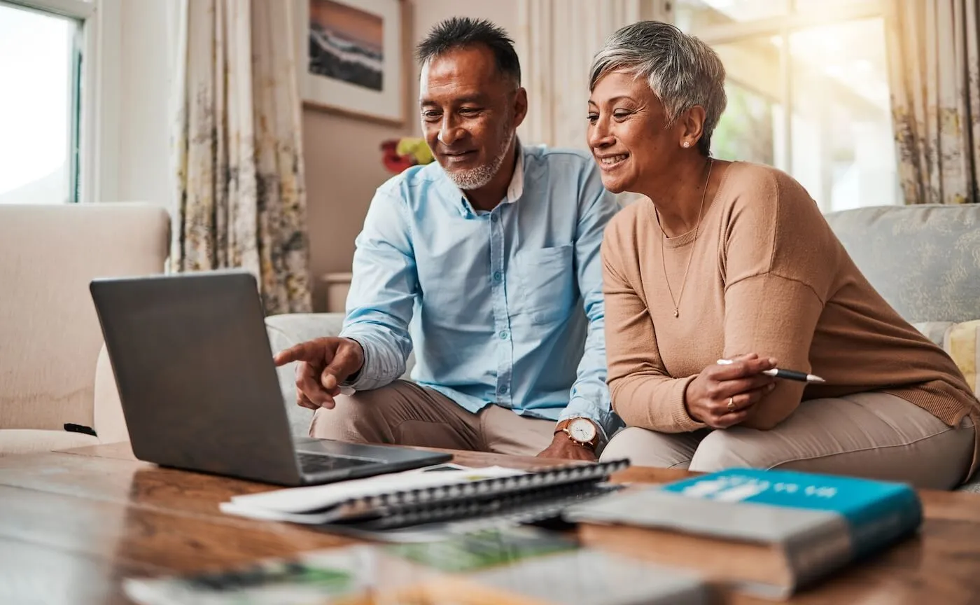 Mature couple checking something on the laptop in their living room