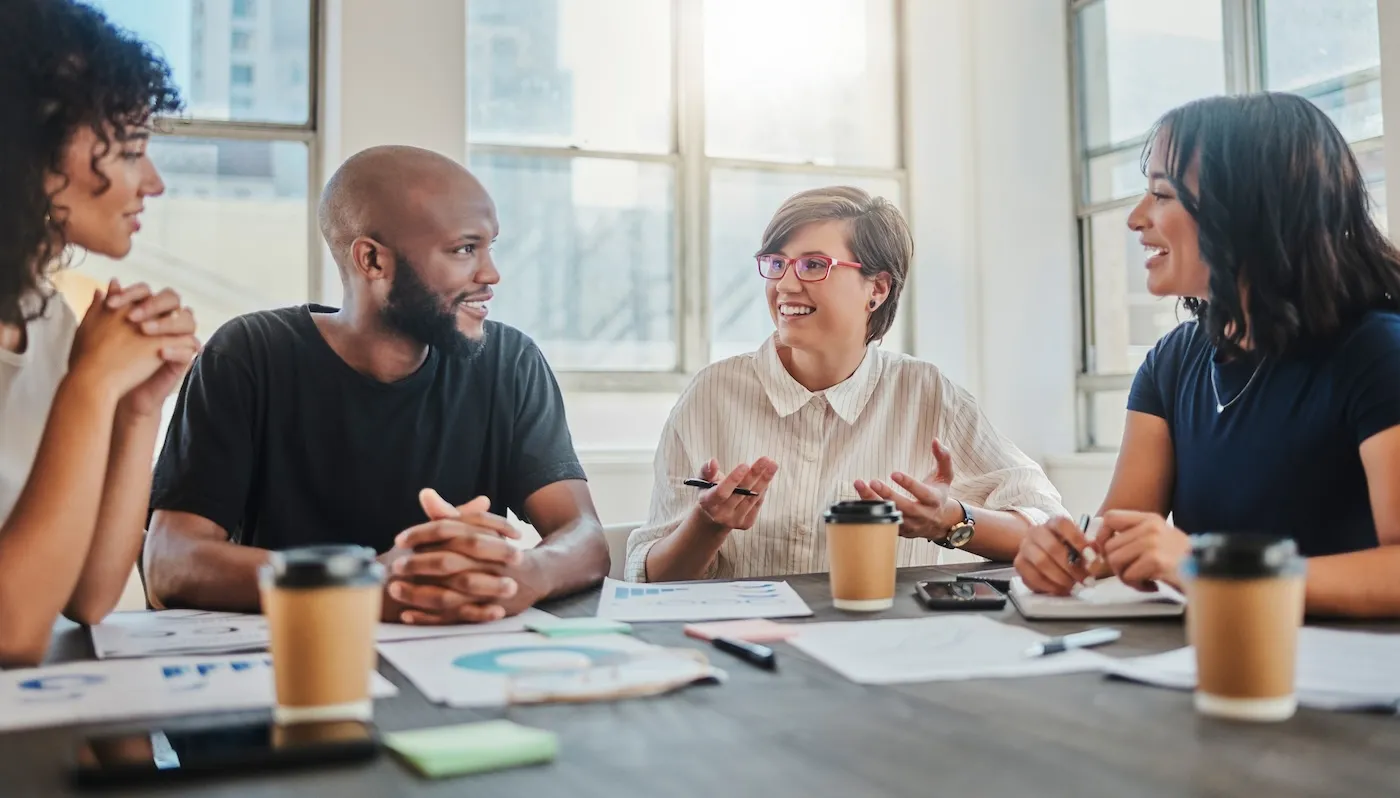 A group of four people discussing an equity fund.