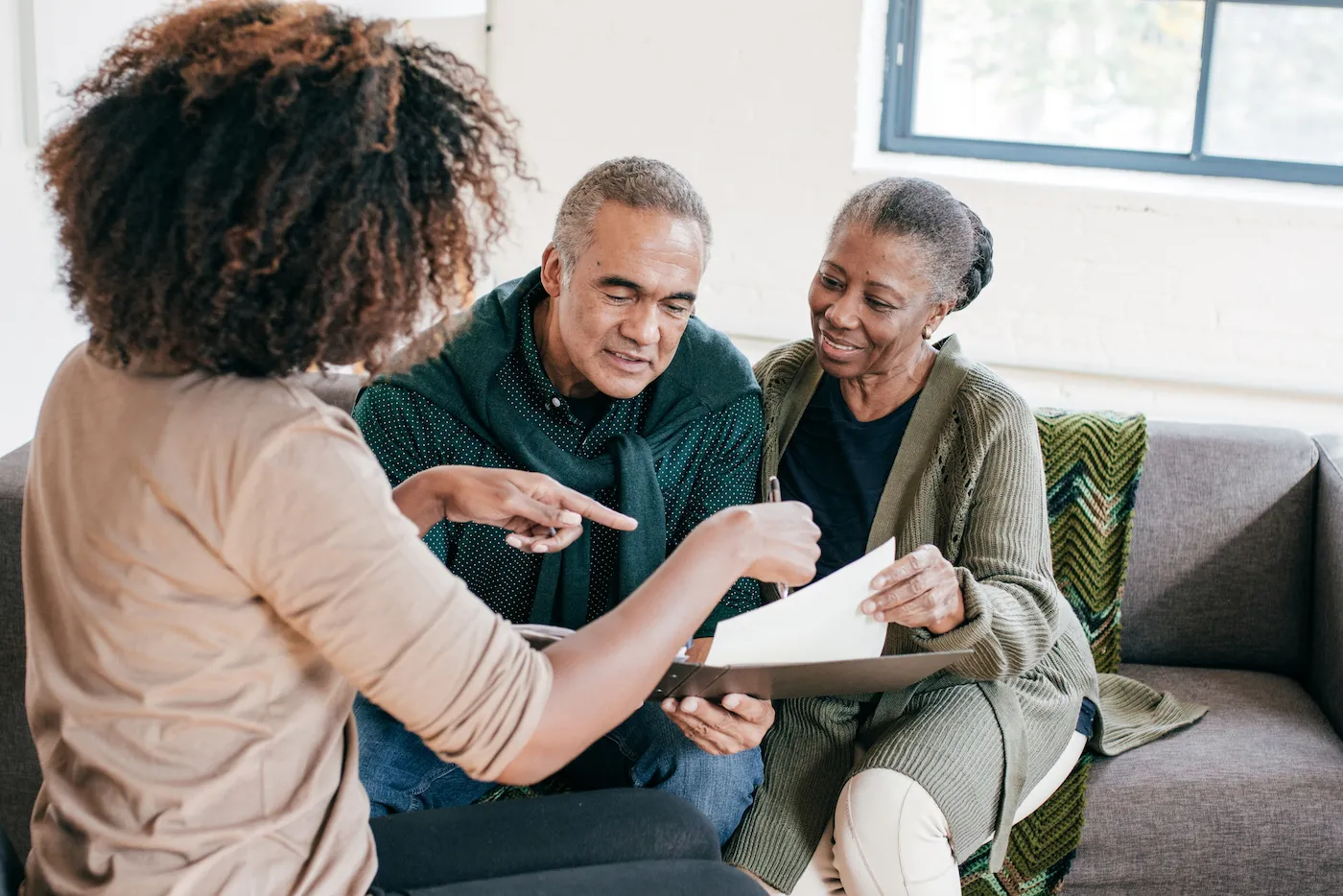 Financial advisor visiting seniors couple for consultation at home