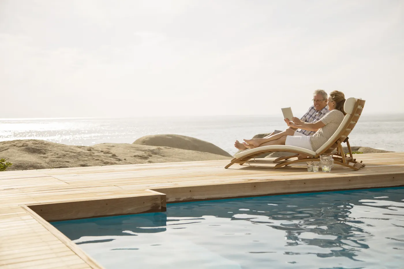 Older couple relaxing by pool