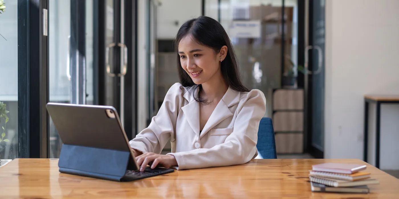 A woman researching mortgage refinancing on a digital tablet.