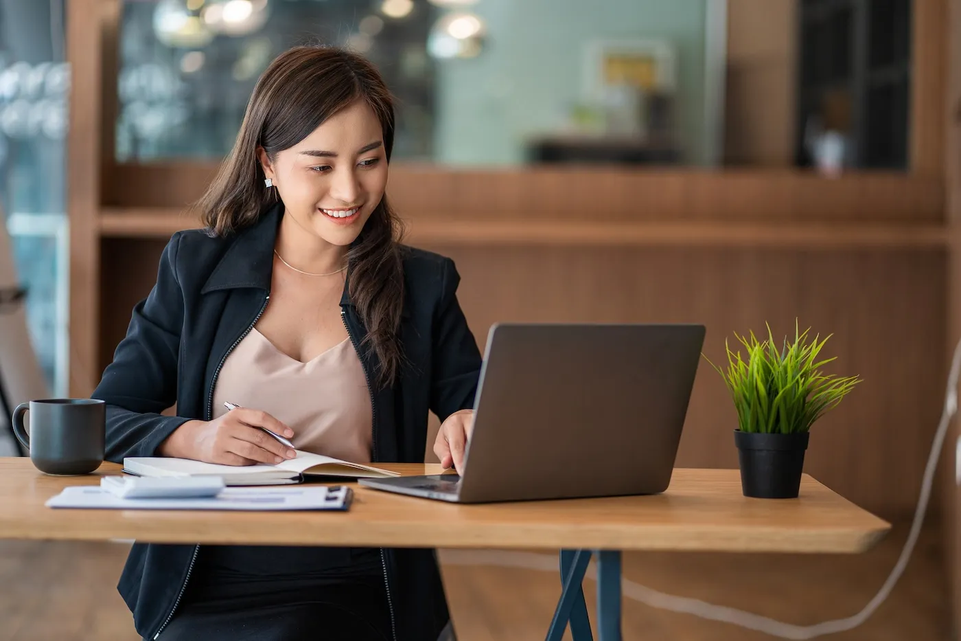 A real estate agent working with laptop and mobile phone.