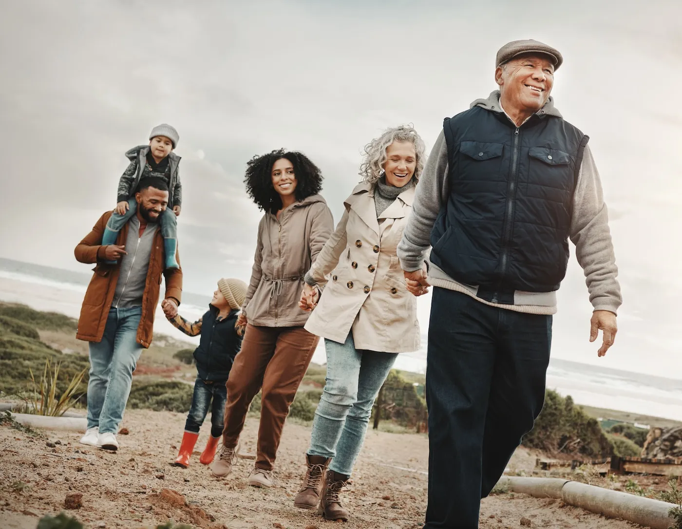 Family holding hands, hiking outdoor together in nature.