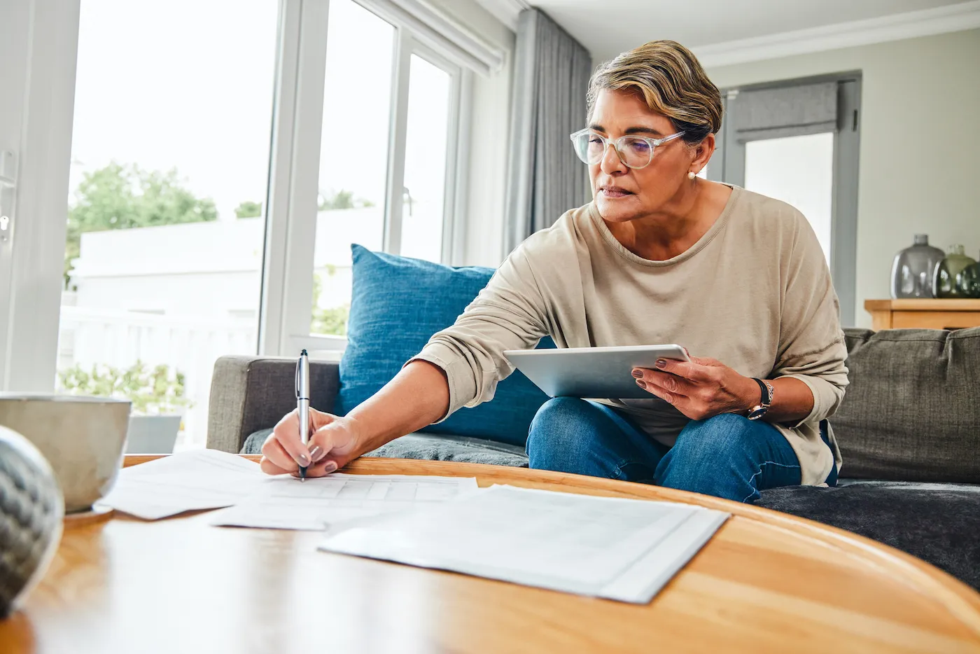 Woman sitting on her couch doing her taxes