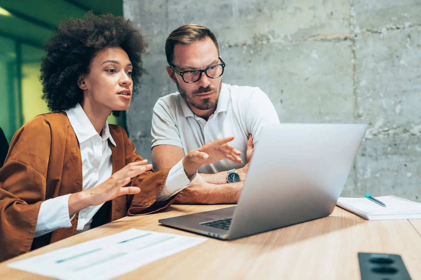 Woman explaining to man beside her minimum required distributions.