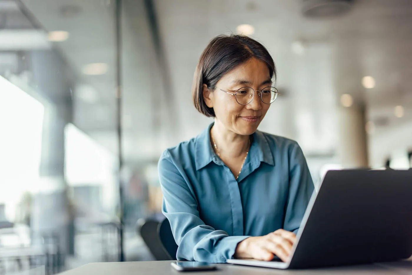 Woman in glasses looking up mortgage loan information.